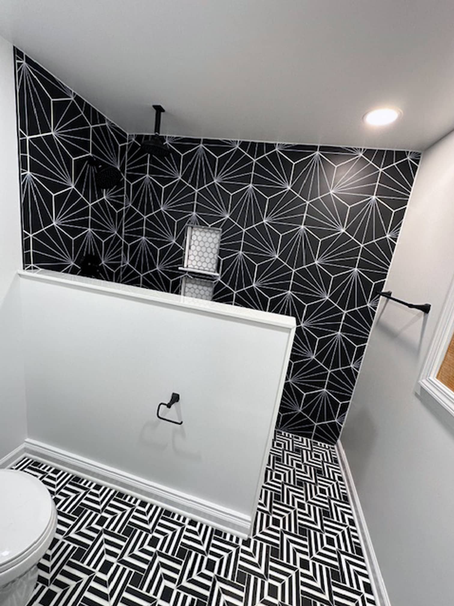 Modern bathroom with black geometric accent tile in a Gahanna, OH renovation